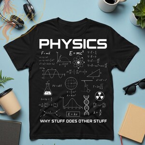 May include: Black t-shirt with the word "PHYSICS" in white block letters, along with various physics formulas and diagrams. The text "WHY STUFF DOES OTHER STUFF" is printed below the formulas.