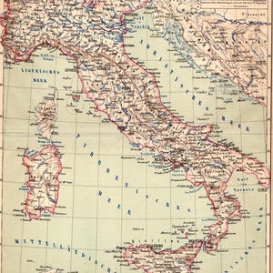 May include: An antique-style paper map of Italy featuring detailed topography, cities, and regional borders in muted tones of pink, beige, and blue. The map includes text labels for major locations, bodies of water, and a scale indicator in the corner.