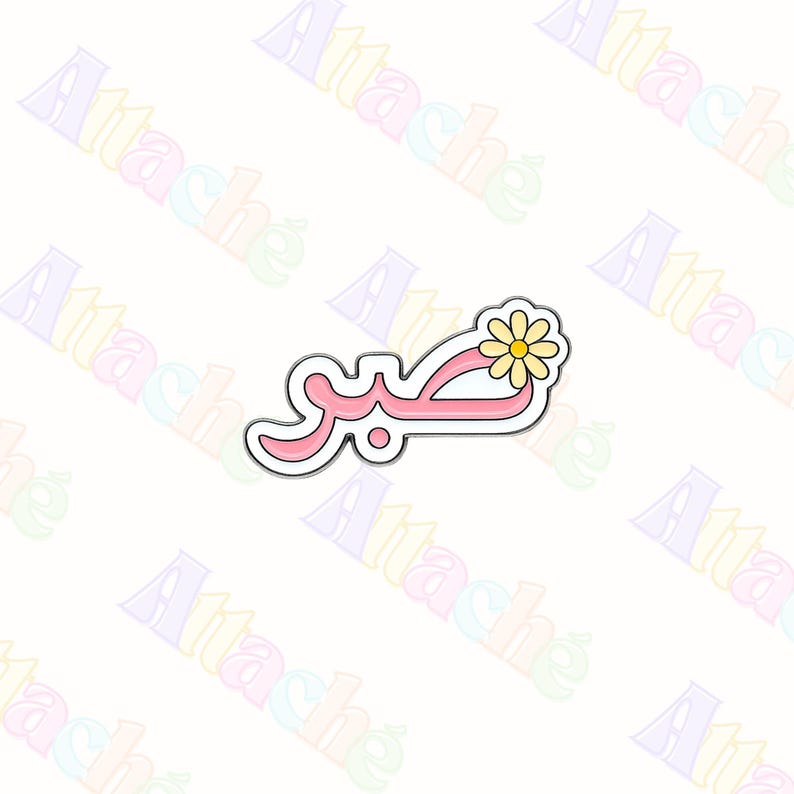 May include: A metal enamel pin featuring the Arabic word for patience, Sabr, written in pink script with a white outline. A small yellow daisy with a brown centre is attached to the top right of the lettering, creating a floral accent on the pin.