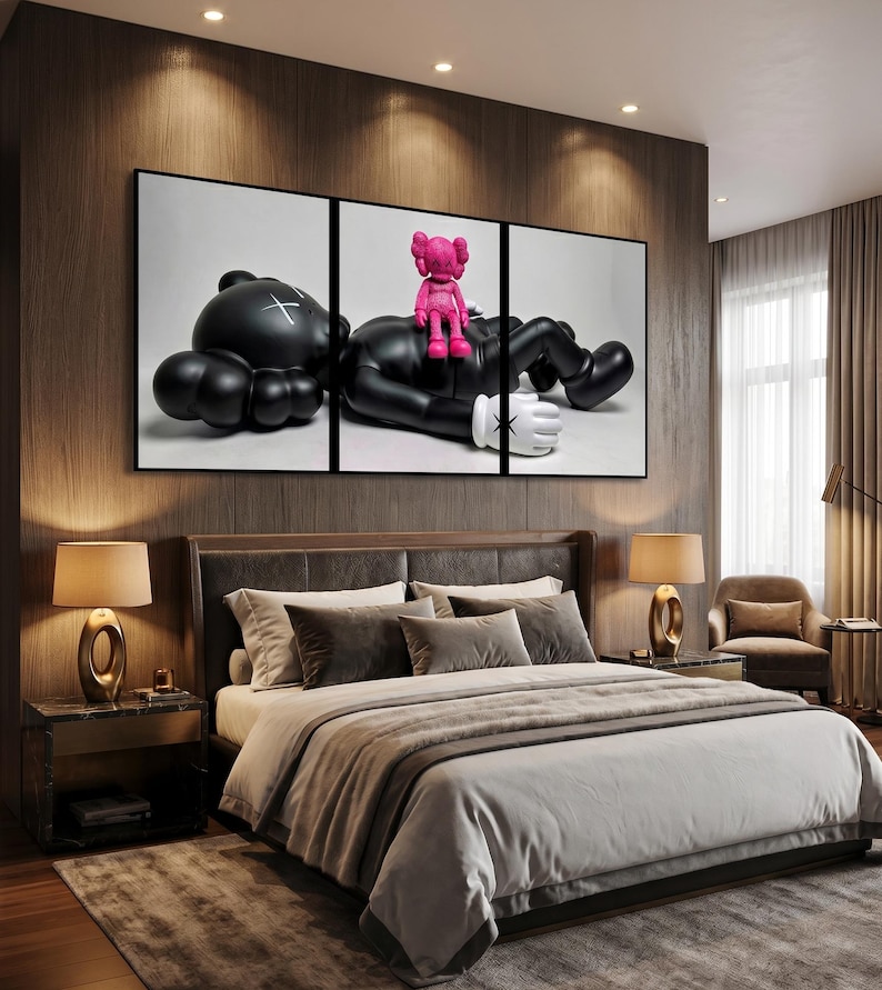 May include: A triptych wall art set featuring a large black character with white X-shaped eyes lying down, with a smaller bright pink character sitting on its chest. The figures have rounded limbs and white gloved hands against a plain background.