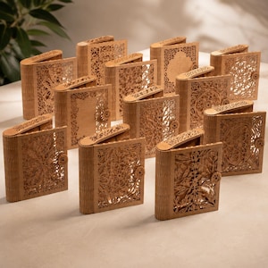 May include: A collection of intricately carved wooden boxes, each with a unique floral or geometric design. The boxes are rectangular with rounded lids and small clasps. The wood has a warm, natural tone.