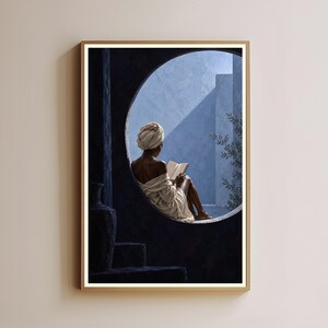 May include: A framed wall art print depicting a person with a head wrap and robe sitting in a circular window frame reading an open book. The scene features deep blue shadows, bright natural light, and a glimpse of green foliage in the background.