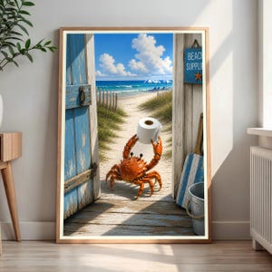 May include: A framed wall art print depicting an orange crab holding a roll of white toilet paper on a sandy path. The scene is framed by weathered blue wooden doors opening to a beach with blue ocean waves, white clouds, and a blue sign reading BEACH SUPPLIES.