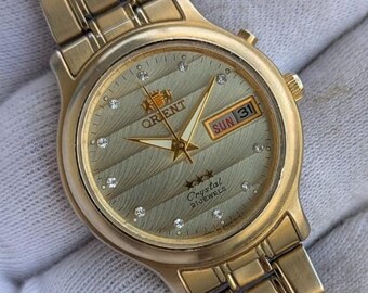 Montre automatique vintage Orient - Jour/Date dorés, 21 rubis, montre-bracelet japonaise