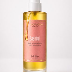 Bashful luxury perfume oil bottle on clean white background, showcasing pump dispenser ultra concentrated floral gourmand body oil with long lasting fragrance, moisturizing glow oil and feminine soft girl aesthetic.