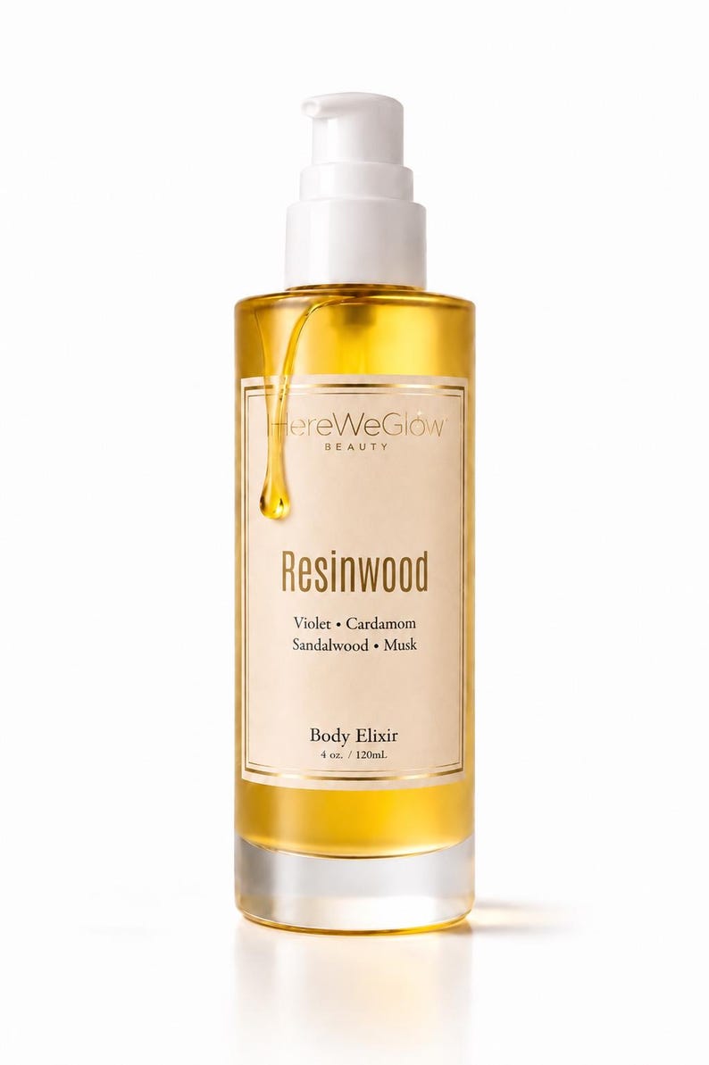 Close up of body oil pump showing lightweight fast absorbing texture, moisturizing woody body oil for dry skin non greasy glow oil.