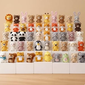 May include: A collection of small, crocheted animal figurines, including bears, bunnies, pandas, and penguins. The handmade toys are in various colors, such as yellow, brown, white, and gray. The figurines are arranged on white blocks.