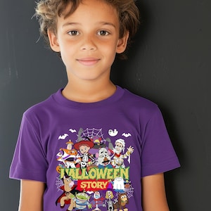 May include: A purple short-sleeved t-shirt featuring a graphic print of various animated characters dressed in Halloween costumes. The text reads "HALLOWEEN STORY" and "TO INFINITY AND BOO-YOND" in yellow and green lettering against a dark background.
