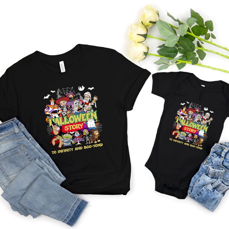 May include: A black short-sleeved t-shirt and a black short-sleeved baby bodysuit, both featuring a graphic print of animated characters in Halloween costumes with the text JALLOWEEN STORY TO INFINITY AND BOO-YOND in green and red lettering.