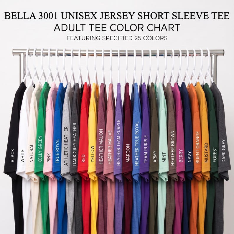May include: A Bella 3001 unisex jersey short sleeve tee adult tee color chart featuring 25 shirts hanging on white hangers. The shirts are displayed in a row, showcasing a variety of colors including black, white, red, blue, green, and yellow.