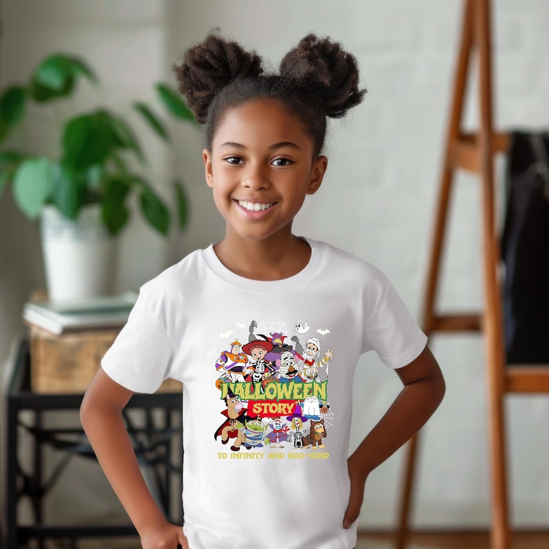 May include: A white short-sleeved t-shirt featuring a colorful graphic of various cartoon characters dressed in Halloween costumes. The text reads HALLOWEEN STORY and TO INFINITY AND BOO-YOND in yellow and red lettering centered on the chest.