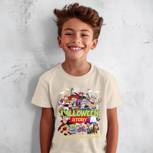 May include: A cream-colored short-sleeve t-shirt featuring a colorful graphic print of various cartoon characters dressed in Halloween costumes. The text reads HALLOWEEN STORY and TO INFINITY AND BEYOND, surrounded by spiderwebs, ghosts, and bats.