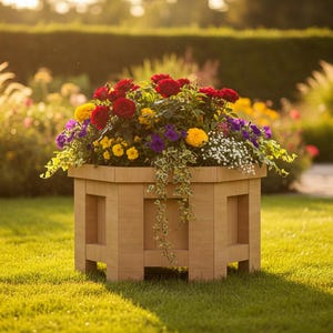 May include: A wooden planter box filled with vibrant red, yellow, purple, and white flowers. The hexagonal planter sits on a grassy lawn, with a hedge and other flowers in the background. The box has a light brown color.