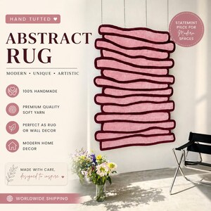 May include: A hand-tufted abstract rug in shades of pink and burgundy, designed for modern spaces. The rug is made with soft yarn and can be used as a rug or wall decor. The text on the image says "Abstract Rug" and "Modern, Unique, Artistic."