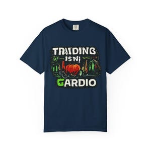 May include: Navy blue t-shirt with a graphic that reads "Training Isn't Cardio." The design features a red heart and green accents. The text is in white and green, with a distressed, vintage style.