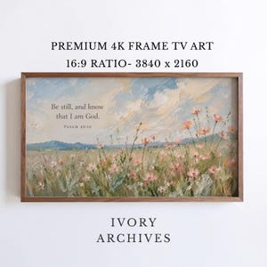 May include: A rectangular digital artwork for a frame TV featuring an oil painting style landscape with pink wildflowers in a field under a blue and white sky. The text reads: Be still, and know that I am God. PSALM 46:10. The art is in a wooden frame.