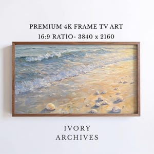 May include: A framed digital art print of a beach scene. The artwork depicts ocean waves washing onto a sandy shore with seashells. The text "PREMIUM 4K FRAME TV ART" and "IVORY ARCHIVES" are visible.