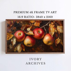 May include: A digital art print for a frame TV featuring an oil painting of three red apples hanging from a branch with golden autumn leaves. The text reads PREMIUM 4K FRAME TV ART 16:9 RATIO- 3840 x 2160 and IVORY ARCHIVES. The frame is dark wood.
