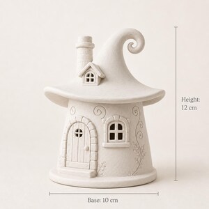 May include: A matte off-white ceramic house figurine with a curved, pointed roof, a chimney, a small arched door, and a window. The structure features embossed swirl and vine patterns. It measures 4.72 inches in height and 3.94 inches at the base.