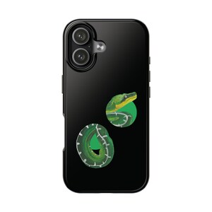 Puede incluir: Funda de teléfono negra con una ilustración de serpiente verde. La serpiente está enroscada en un círculo verde. El diseño utiliza tonos de verde, amarillo y blanco sobre un fondo negro.