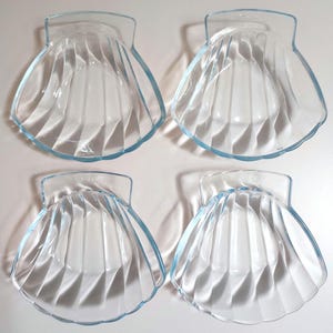 Four glass Pyrex shell dishes