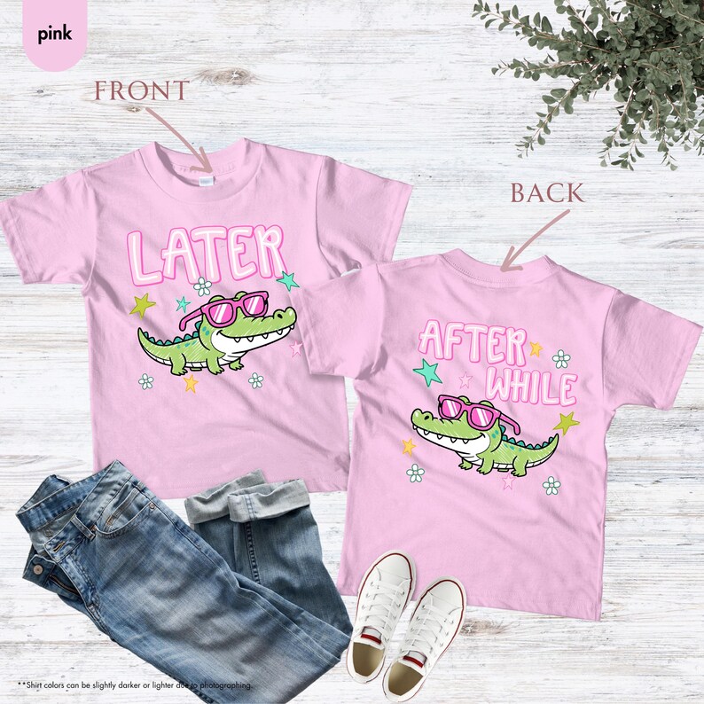 May include: Two pink t-shirts with a cartoon alligator wearing sunglasses. The front shirt says "LATER" and the back says "AFTER WHILE". The shirts are paired with blue jeans and white sneakers.