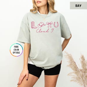 May include: A set of three ceramic mugs with a speckled, matte finish. The mugs are in shades of cream, light gray, and dark gray. Each mug has a simple, minimalist design and a rounded handle.