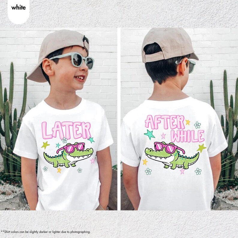 May include: White t-shirts with a cartoon alligator wearing sunglasses. The front of the shirt says "LATER" in pink letters, and the back says "AFTER WHILE". The alligator is green with pink sunglasses.