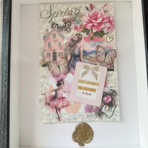 May include: Framed artwork with a spring theme. The collage features a pink house, butterflies, roses, a ballerina, and the word "Spring". A gold seal is at the bottom.
