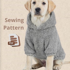 May include: A grey, fluffy dog hoodie on a yellow Labrador Retriever. The hoodie has a hood and long sleeves. The image includes the words "Sewing Pattern" and a PDF icon.