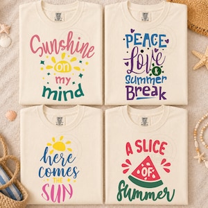 May include: Four cream-colored t-shirts with graphic prints. Top left: 'Sunshine on my mind' with a yellow sun. Top right: 'Peace Love & Summer Break' with hearts. Bottom left: 'here comes THE SUN' with a sun. Bottom right: 'A SLICE OF SUMMER' with a watermelon.