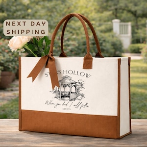 a beige tote bag with a printed design of a gazebo and the text "Stores Hollow" printed on it. The bag is placed on a wooden surface, and there is a sign that says "Next day shipping".