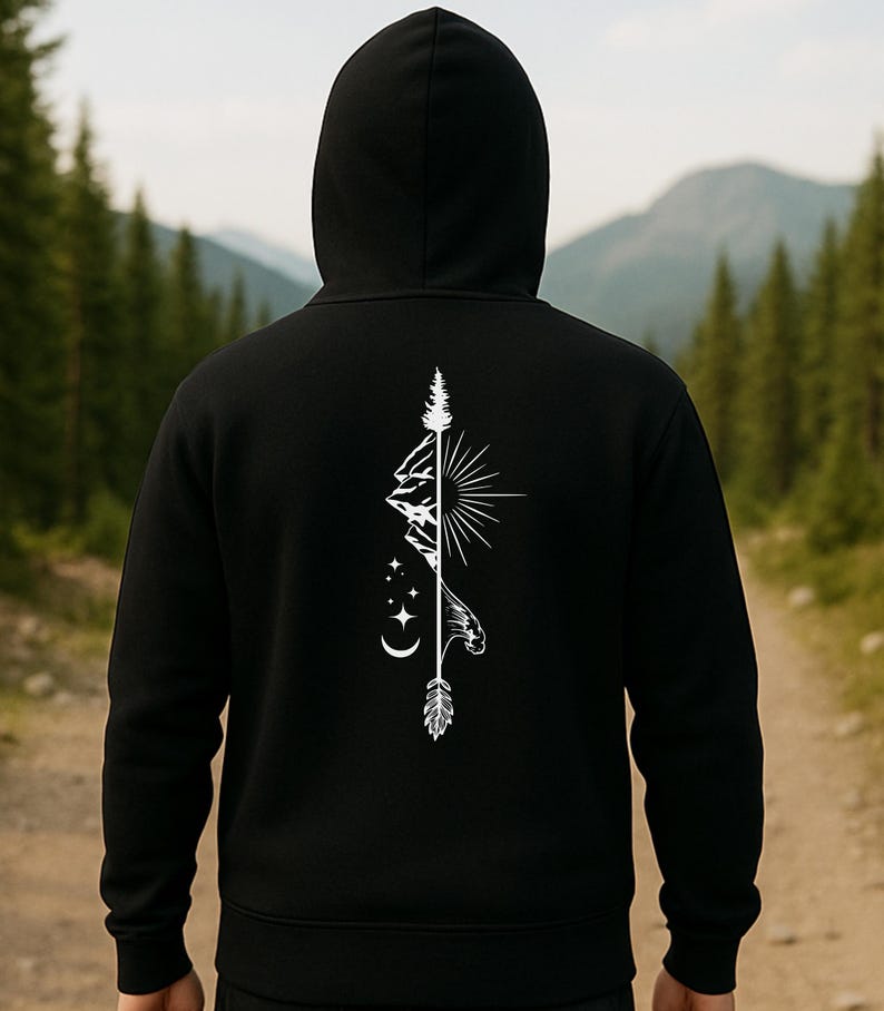 May include: Black hooded sweatshirt with a white graphic design on the back. The design features a mountain range, sun, stars, and an arrow. The sweatshirt is made of a soft material and has a drawstring hood.