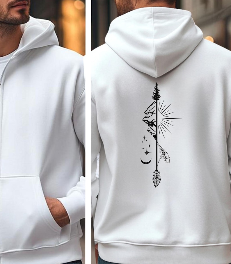 May include: White zip-up hoodie with a front pocket and a hood. The back features a black graphic design of a mountain, sun, stars, and an arrow. The hoodie is made of a soft, comfortable material.