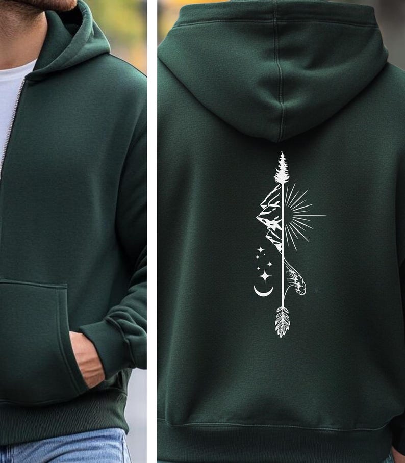 May include: Dark green zip-up hoodie with a white graphic on the back featuring a mountain range, sun, stars, and an arrow. The hoodie has a hood, a front pocket, and a white zipper.