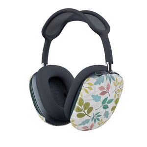 Könnte beinhalten: Dunkelgraue Over-Ear-Kopfhörer mit Ohrmuscheln, die mit einem farbenfrohen Blättermuster auf weißem Hintergrund verziert sind. Die Blätter sind in Grün-, Rosa- und Blautönen gehalten. Das Kopfband ist ebenfalls dunkelgrau.
