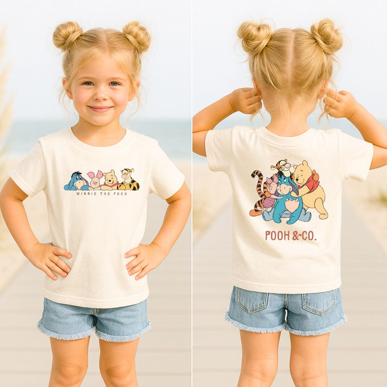 May include: A cream-colored t-shirt featuring a graphic of Winnie the Pooh and friends. The front of the shirt displays the characters in a row with the text "Winnie the Pooh". The back of the shirt shows the characters together with the text "Pooh & Co."
