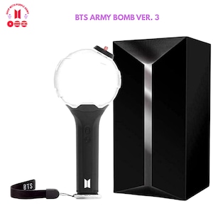 May include: Black BTS Army Bomb Ver. 3 light stick with a clear orb-shaped top and a black handle. The light stick is next to a black box with a silver accent. A black wrist strap with "BTS" is attached.