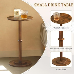May include: A small, round, walnut-topped drink table with a fluted column and a stable base. The table is brown and holds a candle and a glass of amber liquid. The text "SMALL DRINK TABLE" is at the top.