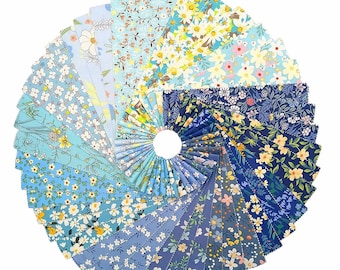 May include: A circular arrangement of fabric squares in various shades of blue. Each square features a different floral pattern, including daisies and other small flowers. The fabrics are arranged in a spiral, creating a visually appealing display of quilting fabric.