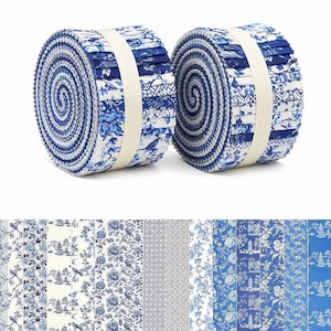 Puede incluir: Dos rollos de tiras de tela, conocidos como jelly rolls, que presentan una variedad de patrones en azul y blanco. Los diseños incluyen motivos florales, cuadrículas geométricas e ilustraciones de pagodas. Cada rollo está sujeto con una banda de tela color crema.