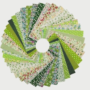 May include: A circular display of fabric squares in shades of green and white. The fabrics showcase floral, polka dot, and striped designs. The arrangement is centered on a white circle, creating a visually appealing pattern.