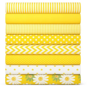 May include: A stack of eight fabric bolts featuring yellow and white patterns including vertical stripes, solid yellow, gingham, polka dots, chevron, tiny dots, stars on a white background, and a daisy floral print on yellow.