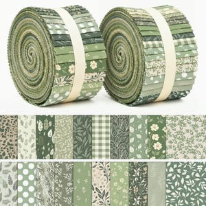 May include: Two rolls of fabric strips, known as jelly rolls, featuring a variety of green and cream patterns. The designs include floral prints, polka dots, gingham checks, and botanical leaf motifs, all secured with a white paper band.