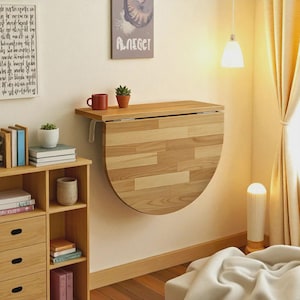 May include: A set of three ceramic canisters with lids. The canisters are white with a blue floral pattern. The largest canister is 8 inches tall, the medium is 7 inches, and the smallest is 6 inches.