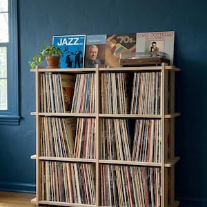 May include: A set of three ceramic mugs with a speckled, matte finish. Each mug features a different color: light blue, cream, and gray. The mugs have a simple, modern design with a rounded shape and a handle.