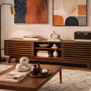 May include: A handmade, wooden cutting board with a natural wood grain. The board is rectangular with a rounded handle and measures approximately 18 inches long and 12 inches wide.