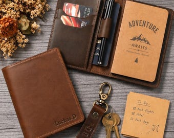 May include: A brown leather passport holder with the name Luckas.D embossed on the front. Inside, it holds a notebook with the text Adventure Awaits, a black pen, and two cards. A matching leather keychain with keys and a To Do list note are included.