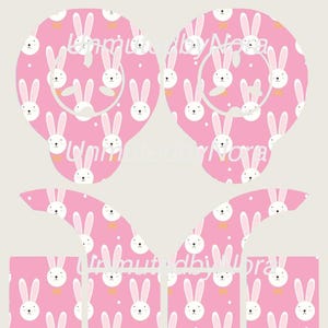 Puede incluir: Cubiertas de pezones y pezones con temática de conejos rosas con un patrón repetido de conejos blancos con pajaritas amarillas. El texto "Unmuted by Nora" está en la esquina superior izquierda.