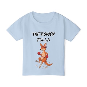 May include: Light blue t-shirt with the text "THE ROWDY FULLA" above a cartoon kangaroo wearing a red headband and boxing gloves. The kangaroo is in a fighting stance, with its arms up and legs bent.